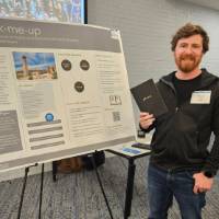 Nayt Boyd standing in front of his poster presentation